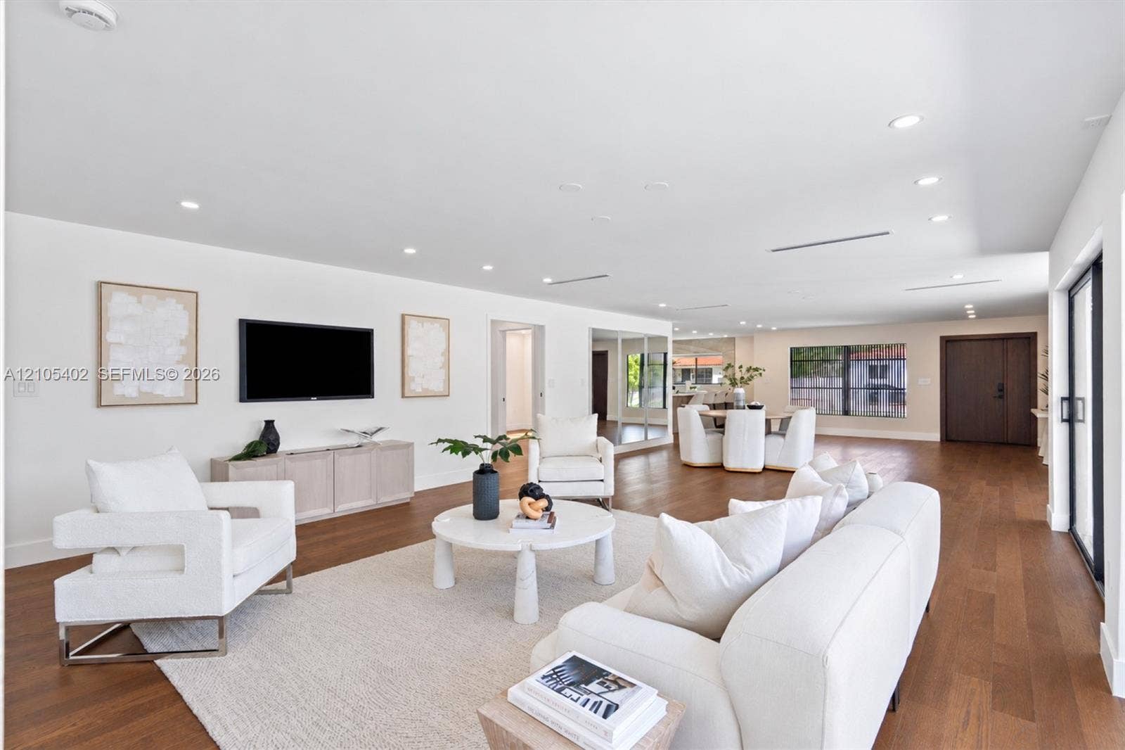 1911 SW 18th Avenue, Miami, FL 33145 Open-concept floor plan featuring wood-finish flooring, recessed lighting, neutral interior palette, and sliding glass doors