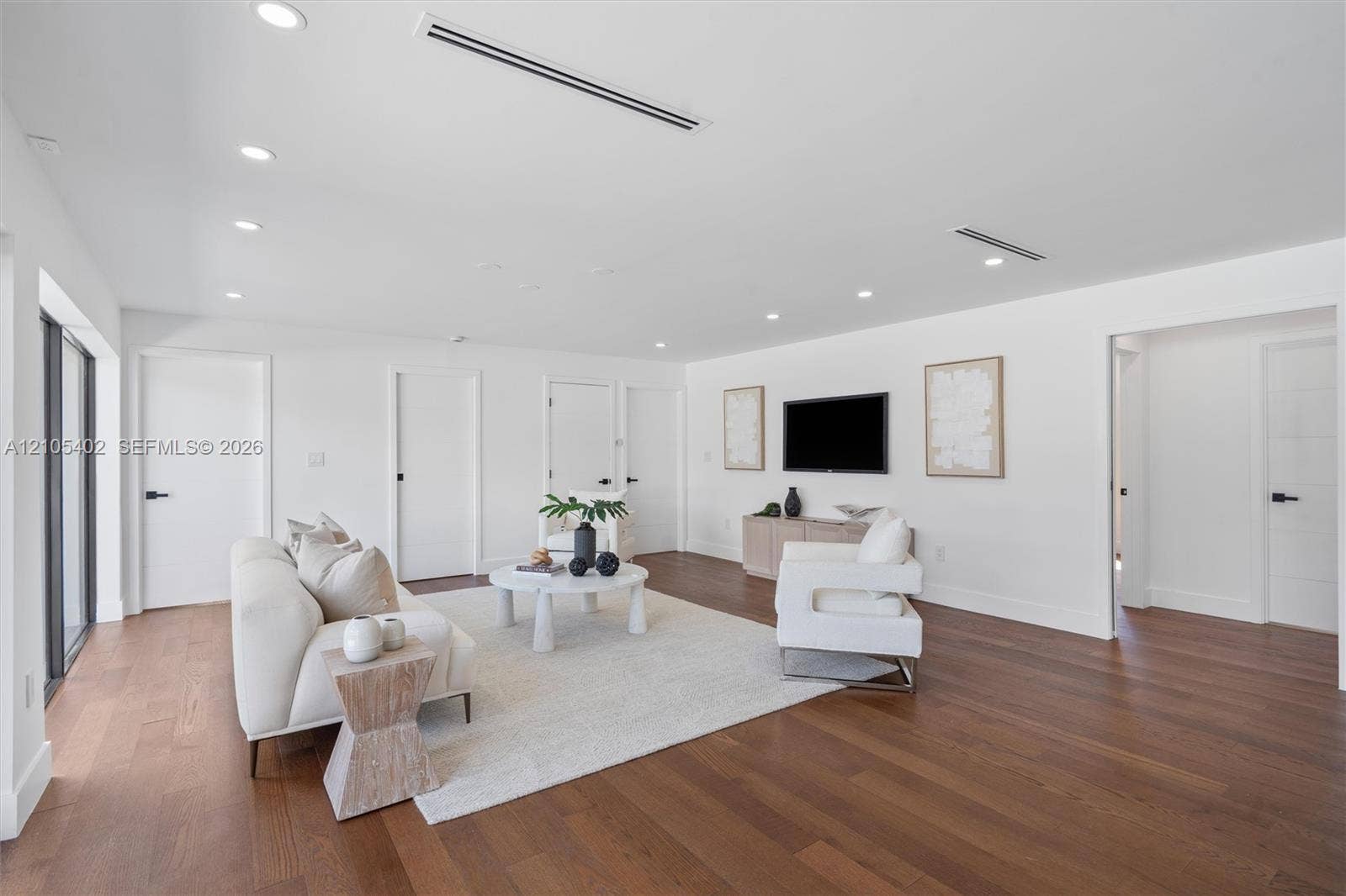 1911 SW 18th Avenue, Miami, FL 33145 Open-concept interior featuring wood-finish flooring, recessed lighting, linear HVAC diffusers, and solid-core doors with matte black hardware