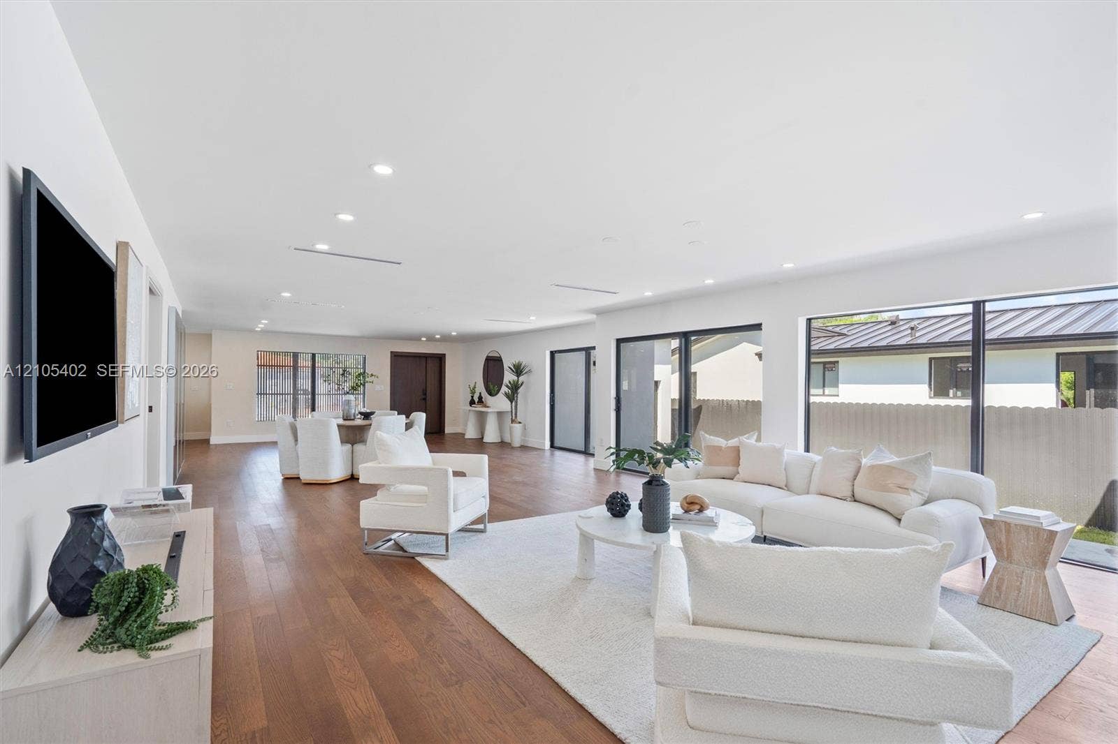 1911 SW 18th Avenue, Miami, FL 33145 Open-concept interior featuring wood-finish flooring, recessed lighting, and large sliding glass doors