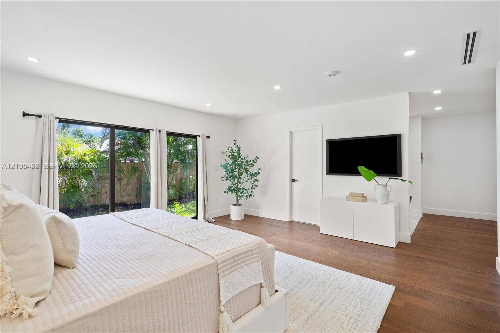 1911 SW 18th Avenue, Miami, FL 33145 Interior space featuring wood-finish flooring, recessed lighting, and large sliding glass doors