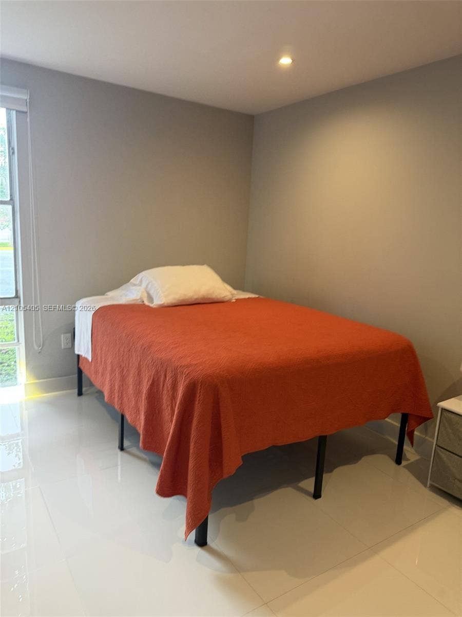 17570 Atlantic Boulevard, #119, Sunny Isles Beach, FL 33160 Recessed ceiling lighting, a window with blinds, and light-colored walls