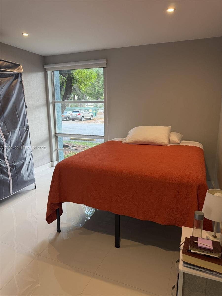 17570 Atlantic Boulevard, #119, Sunny Isles Beach, FL 33160 Recessed ceiling lighting, large window, white tile flooring, and neutral wall tones
