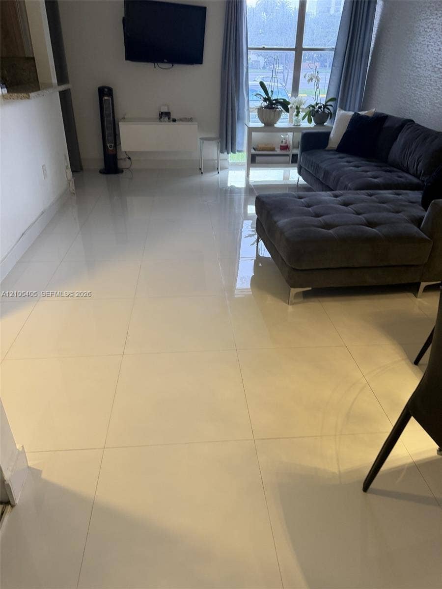 17570 Atlantic Boulevard, #119, Sunny Isles Beach, FL 33160 White tile flooring extends throughout the space