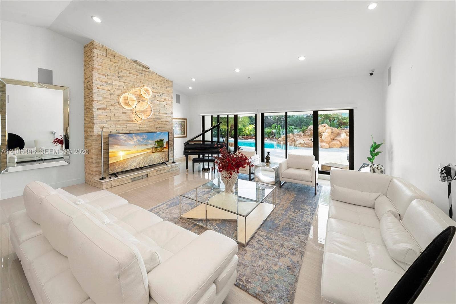 Recessed lighting illuminates a stone-finish accent wall with an integrated display ledge