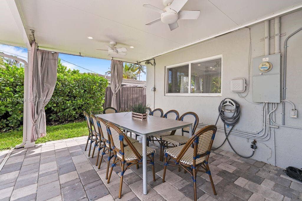 Covered patio area featuring ceiling fans and recessed lighting