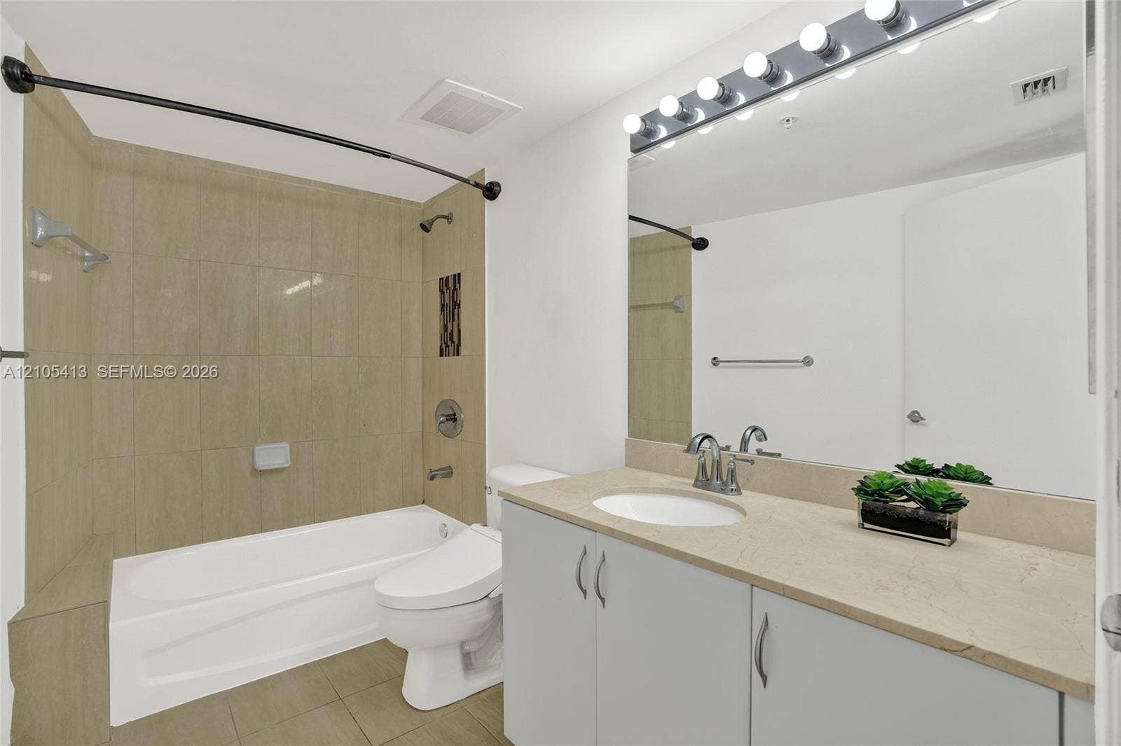 Vanity with an integrated sink, polished chrome faucet, and ample storage cabinetry