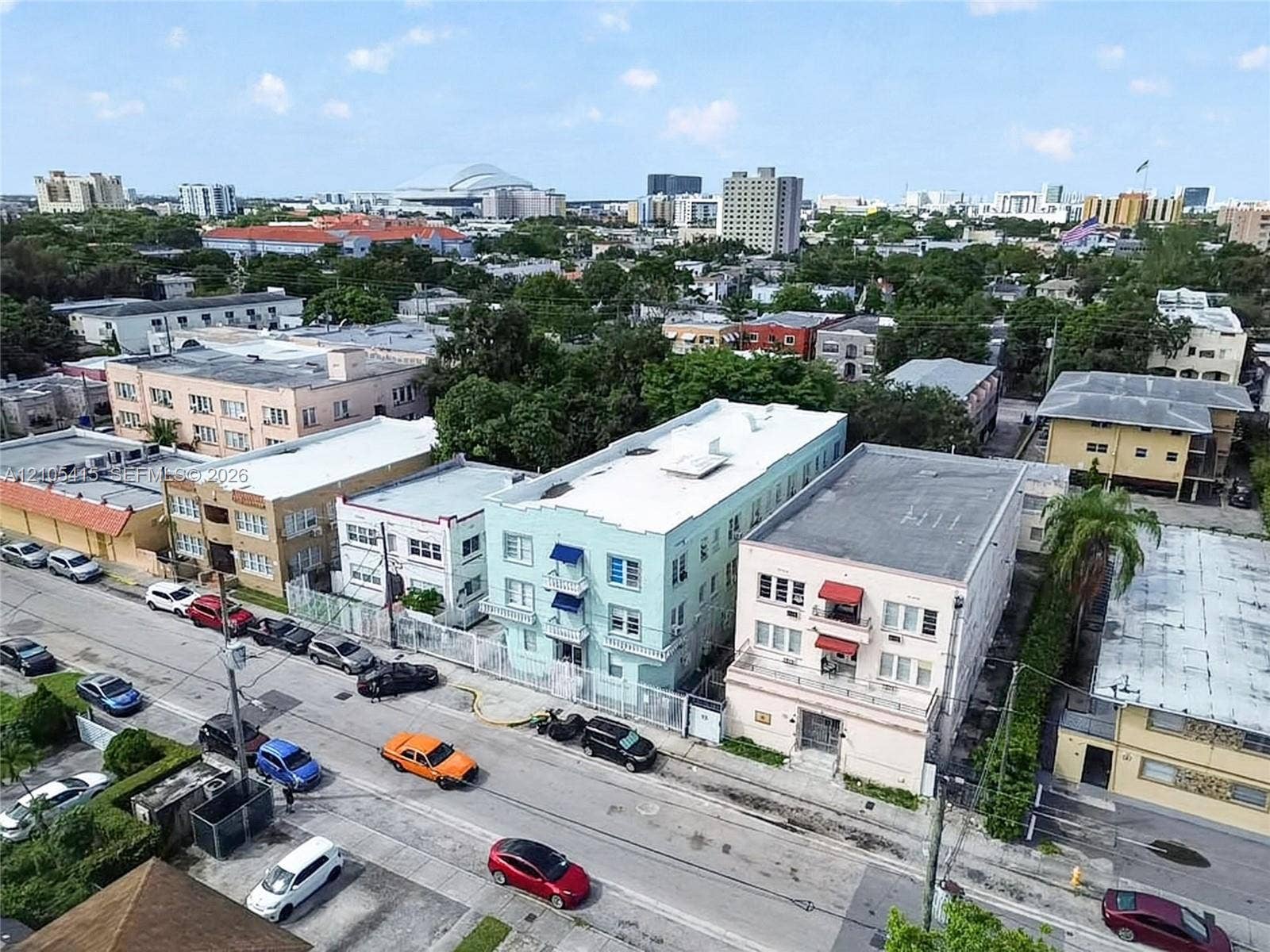967 SW 5th Street, #11, Miami, Miami, FL 33130 Multi-story urban residential building featuring a light-toned stucco exterior, flat roofline, and decorative awning accents