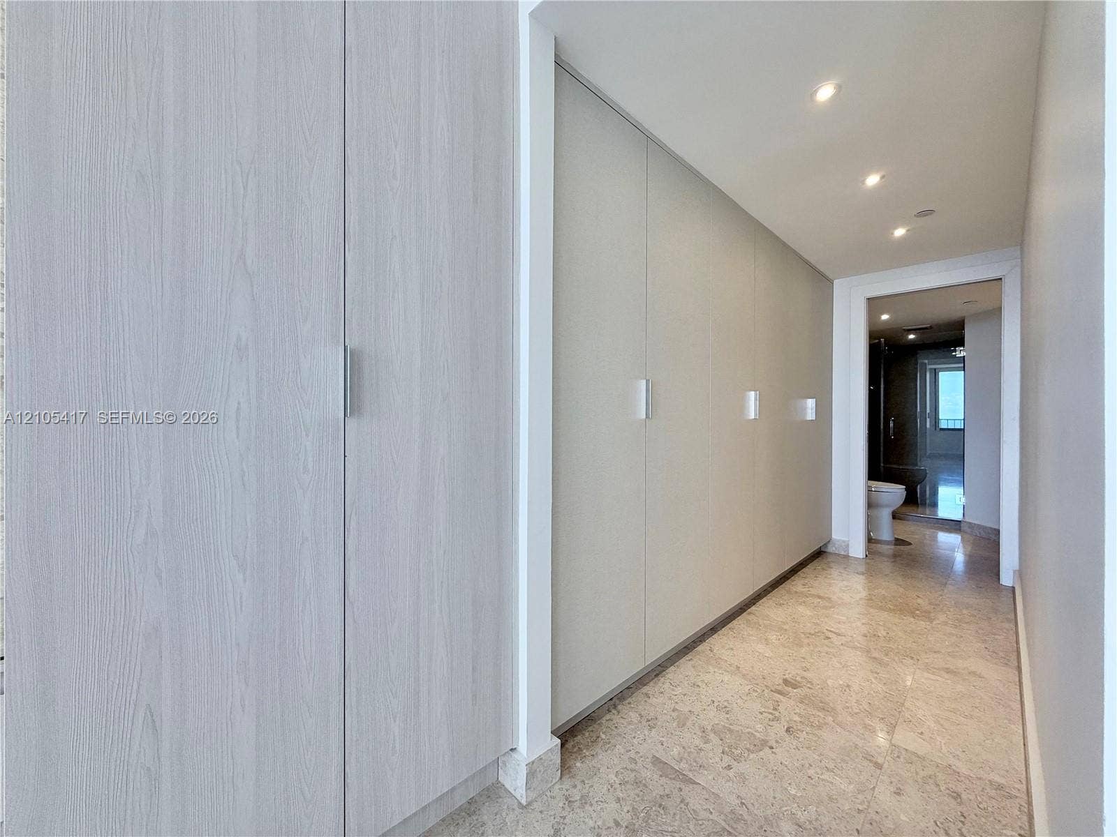 Built-in cabinetry with light wood-finish doors and sleek hardware