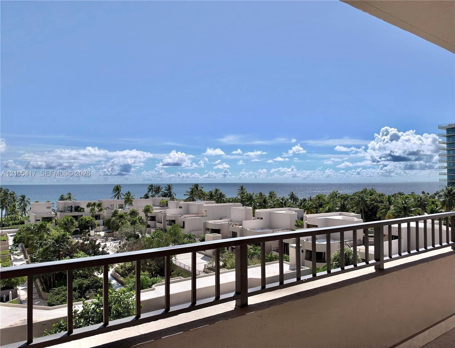Expansive ocean horizon, lush tropical landscaping, and contemporary architecture