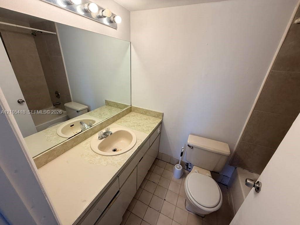 Vanity with integrated sink, full-width mirror, and overhead lighting