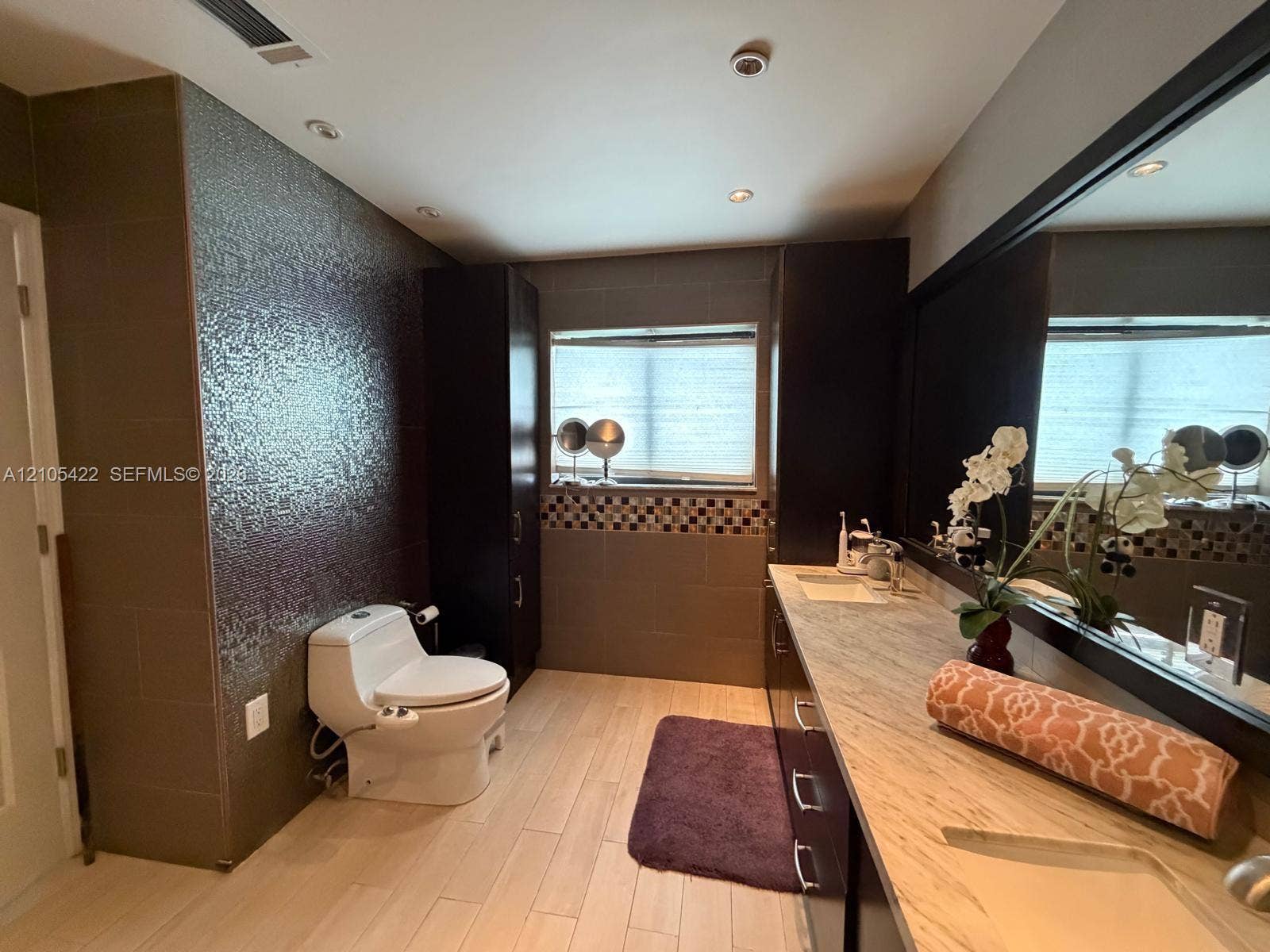 14631 SW 150th Street, Miami, FL 33186 Bathroom featuring a stone-top vanity with dual integrated sinks, dark wood-finish cabinetry, floor-to-ceiling textured tile wall, and recessed ceiling lighting