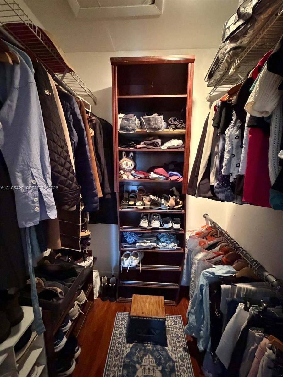 14631 SW 150th Street, Miami, FL 33186 Walk-in closet featuring wood-finish flooring, built-in shelving unit, and integrated wire racking systems