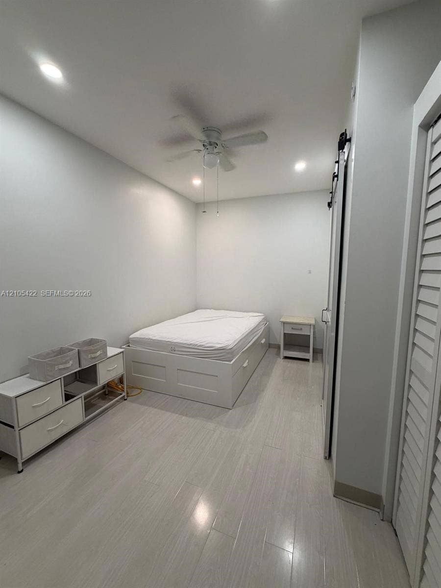 14631 SW 150th Street, Miami, FL 33186 Light-toned wood-finish flooring, recessed lighting, ceiling fan, and louvered closet doors