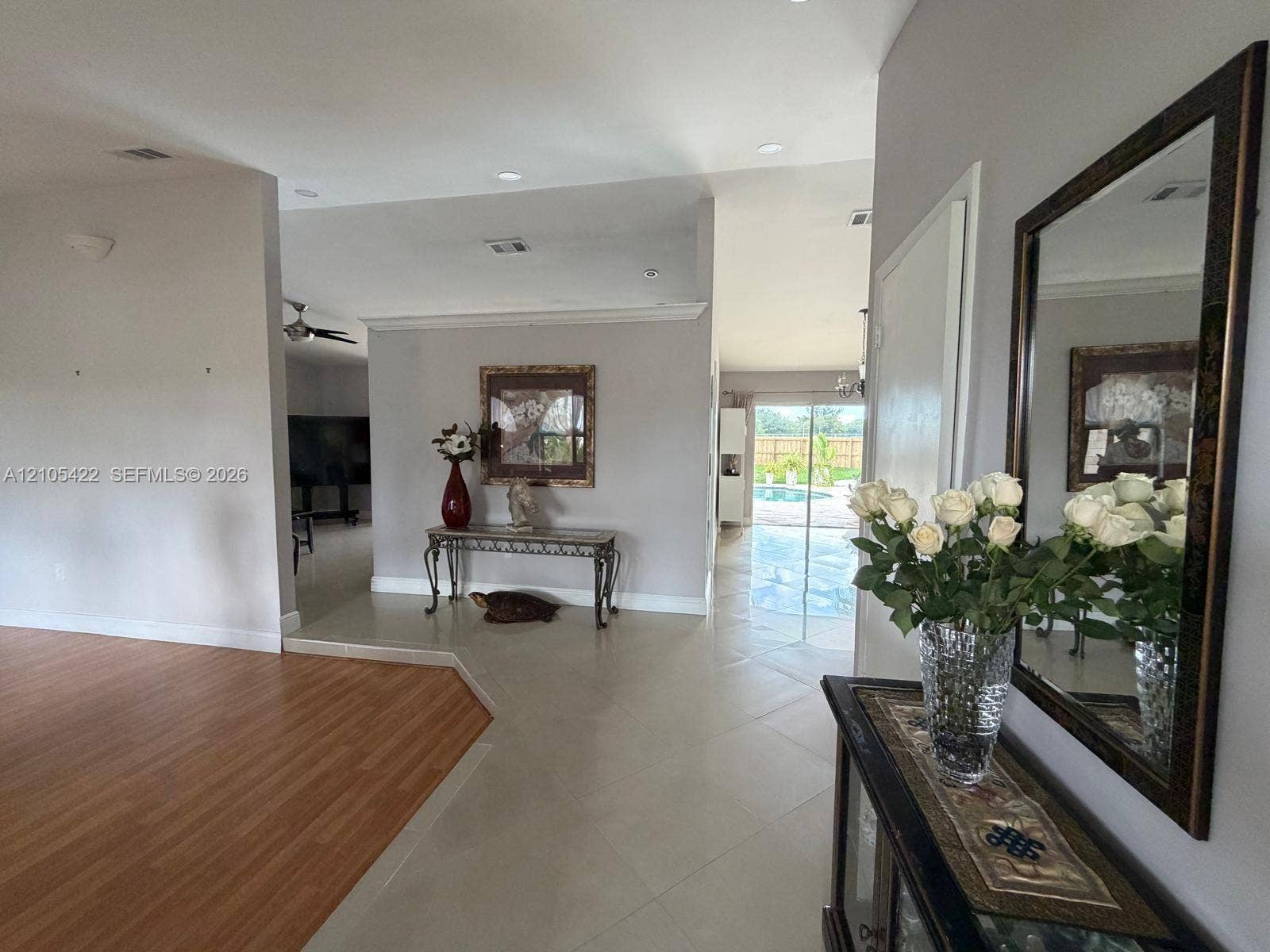 14631 SW 150th Street, Miami, FL 33186 Open floor plan featuring wood-finish flooring, large-format tile flooring, recessed lighting, and crown molding