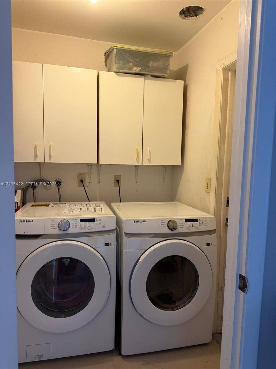 14631 SW 150th Street, Miami, FL 33186 Dedicated laundry space featuring wall-mounted white cabinetry, recessed ceiling lighting, and dedicated water and electrical hookups