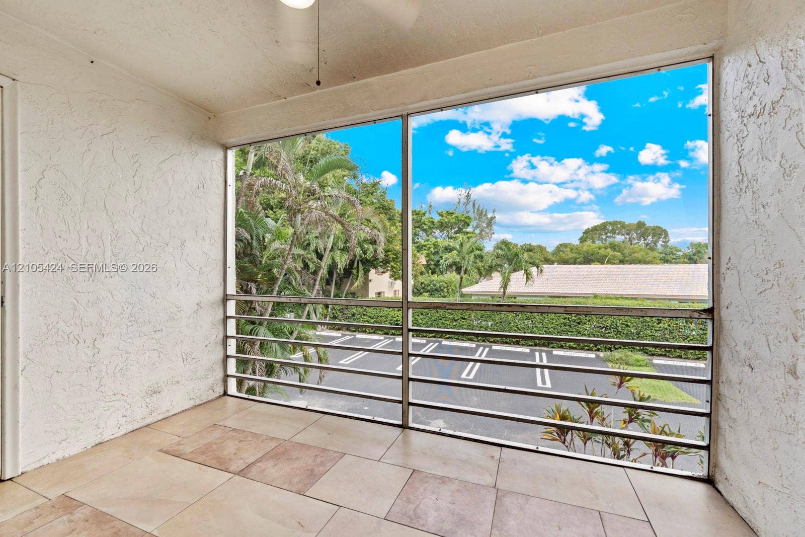Private outdoor balcony with a light-toned tile floor
