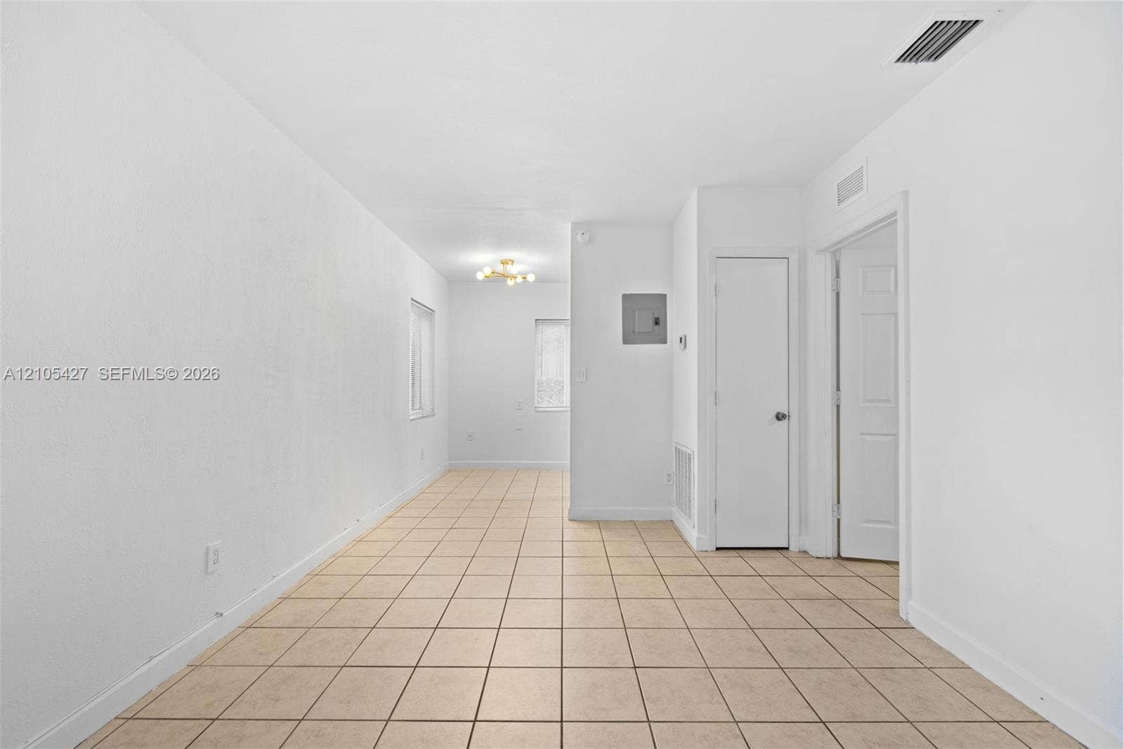 Tile flooring, recessed lighting, and a neutral color palette