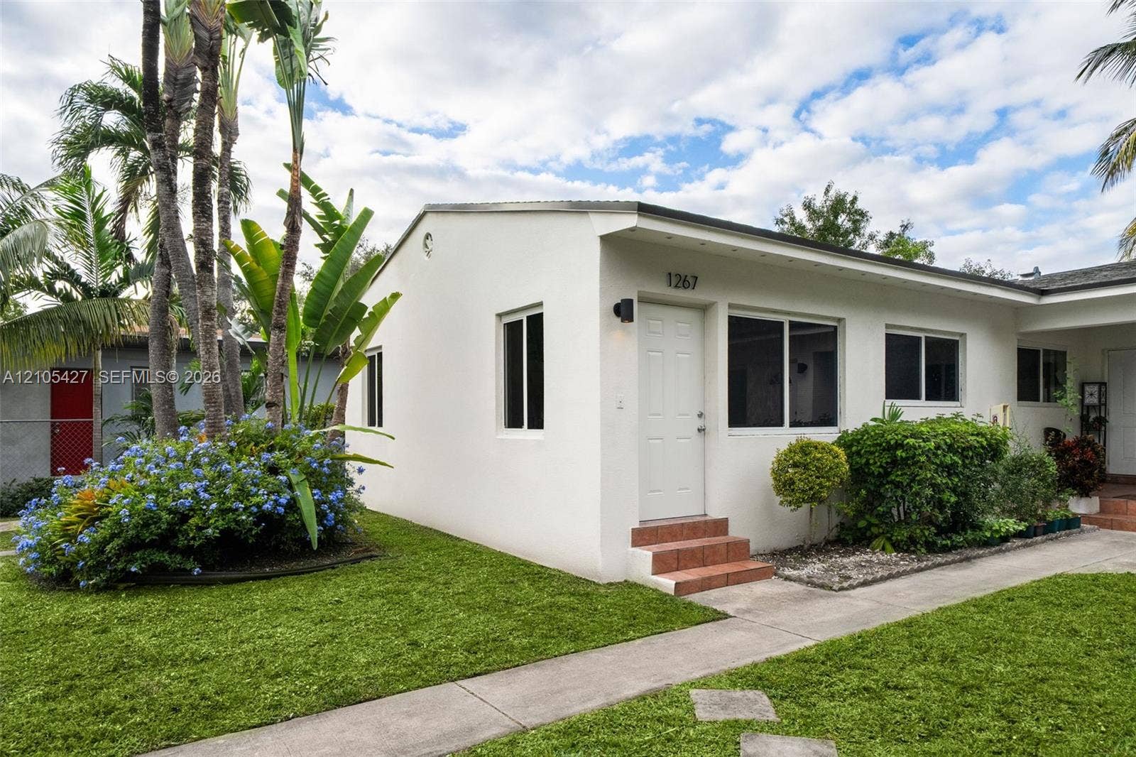 White stucco exterior with a flat roof