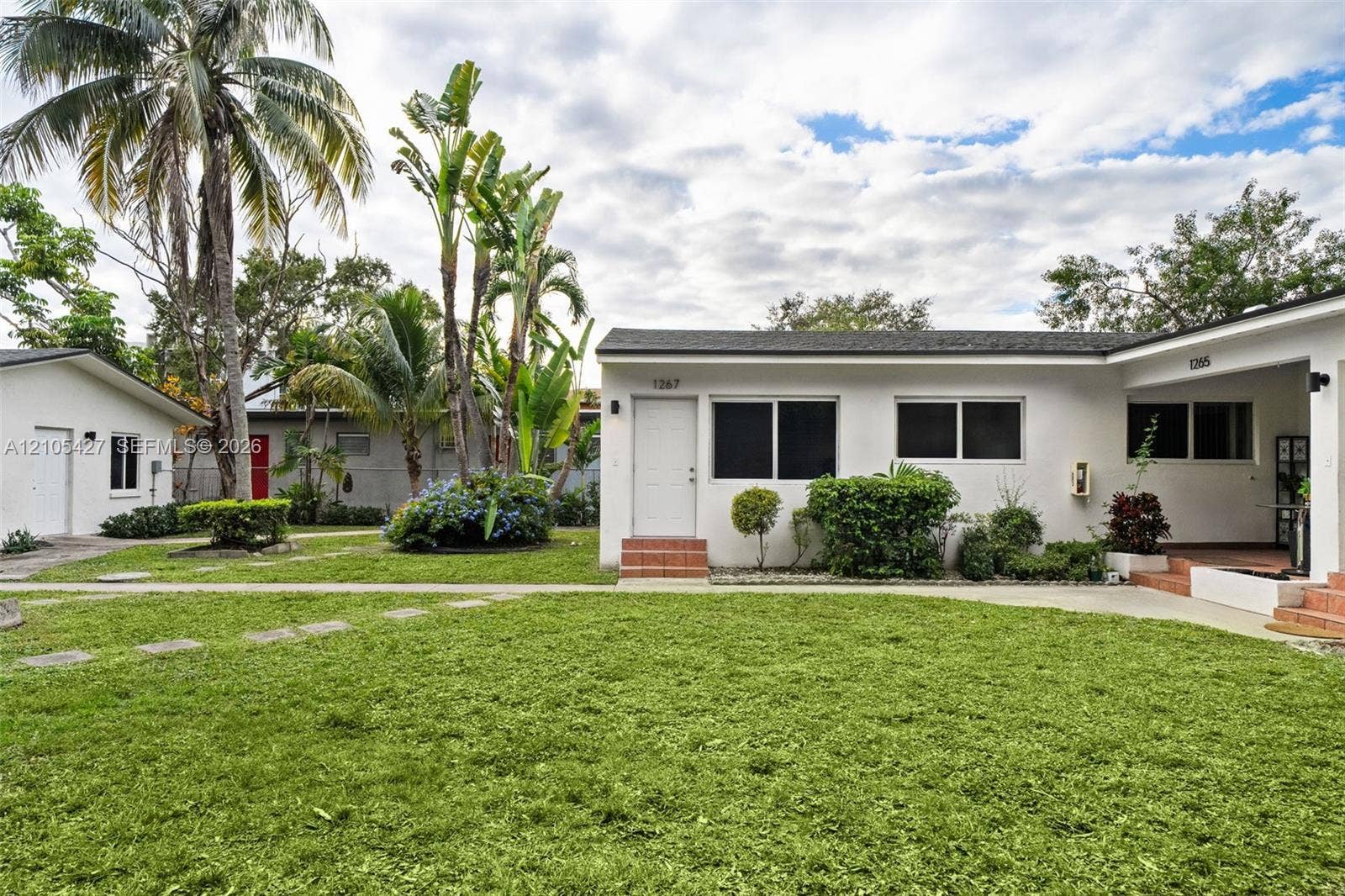 White stucco exterior with dark-framed windows