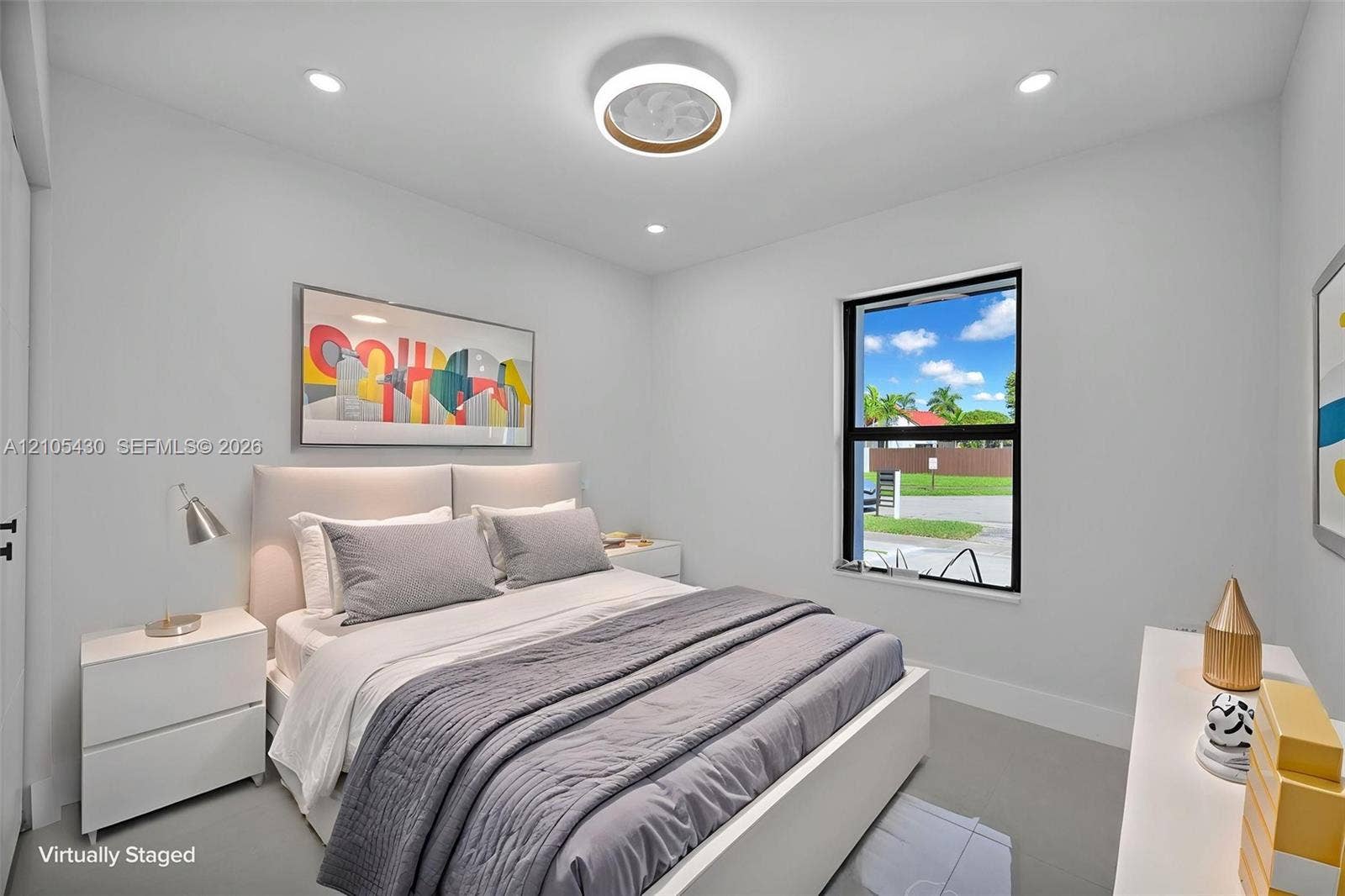 Neutral interior featuring recessed lighting, a contemporary circular flush-mount ceiling fixture, and a single-pane window