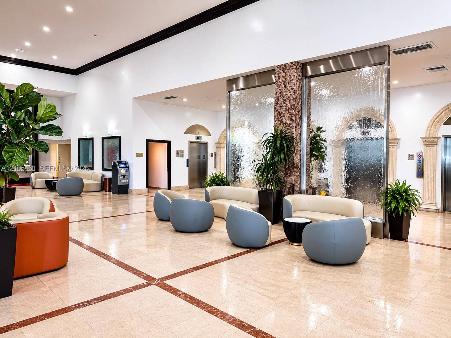 19201 Collins Avenue, #707, Sunny Isles Beach, FL 33160 Spacious open common area featuring polished tile flooring with inlaid accents, high ceilings, and recessed lighting