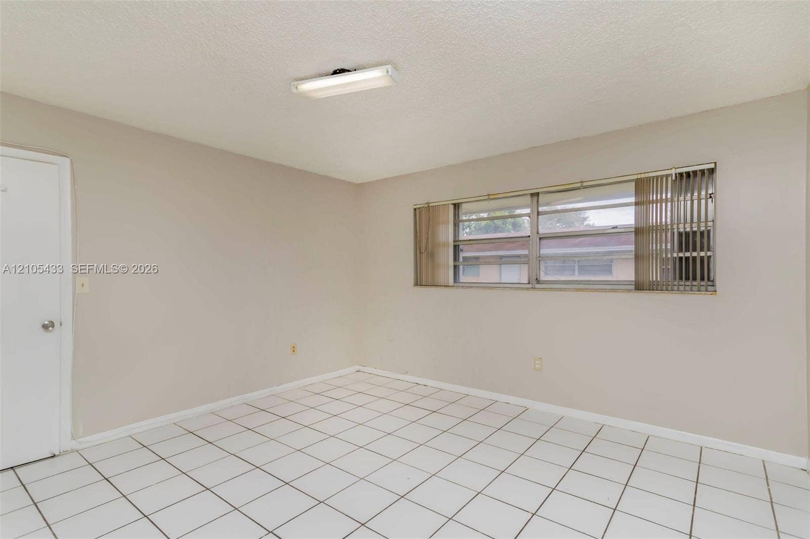 6331 Pierce Street, #1, Hollywood, Hollywood, FL 33024 White square tile flooring, neutral wall tones, and horizontal window blinds