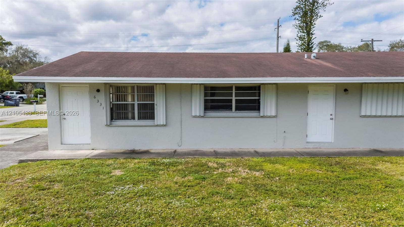 6331 Pierce Street, #1, Hollywood, Hollywood, FL 33024 Light gray stucco exterior with two white entry doors