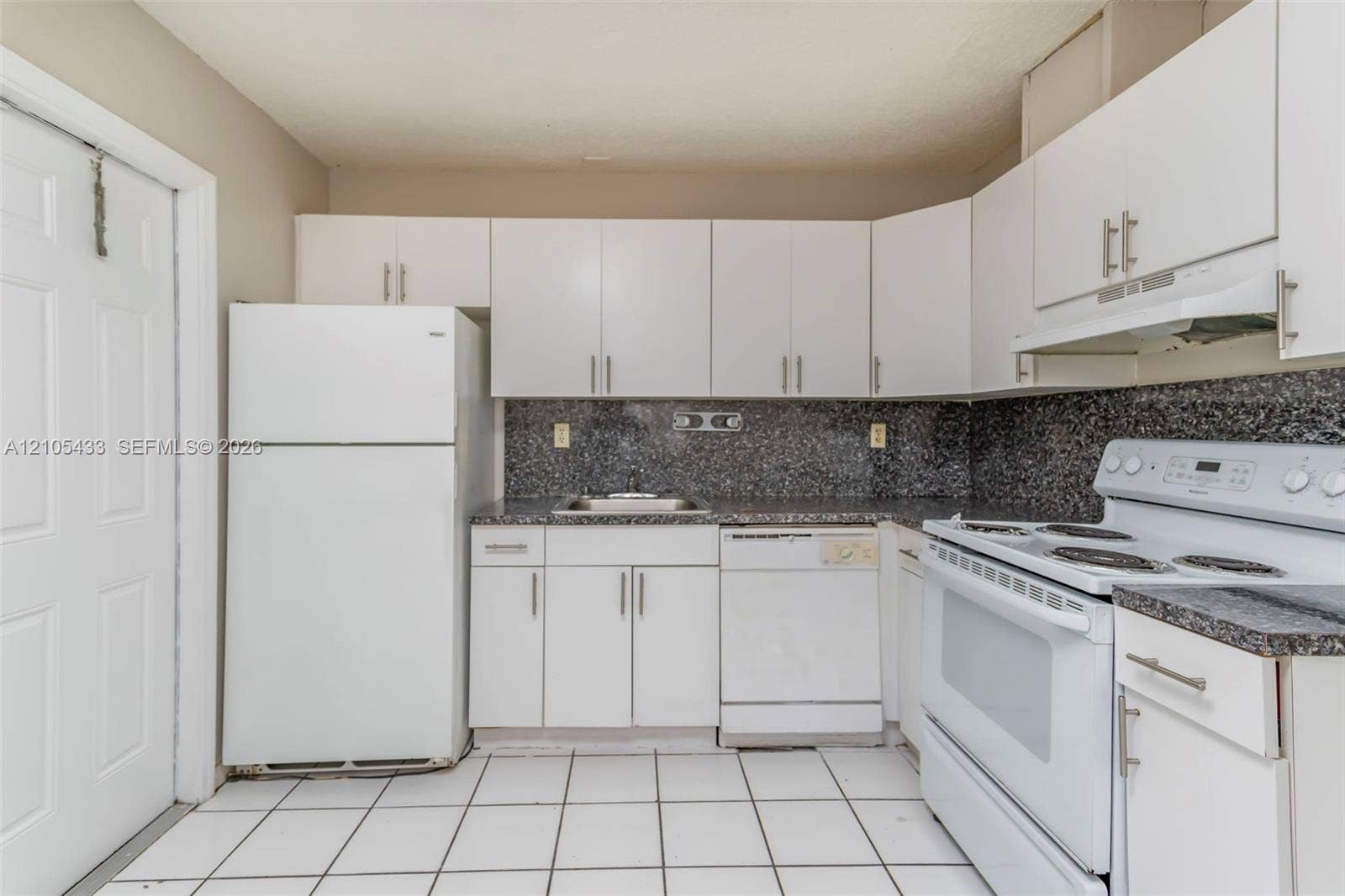 6331 Pierce Street, #1, Hollywood, Hollywood, FL 33024 White cabinetry with brushed nickel hardware, speckled countertops and backsplash, white tile flooring, and integrated white appliances