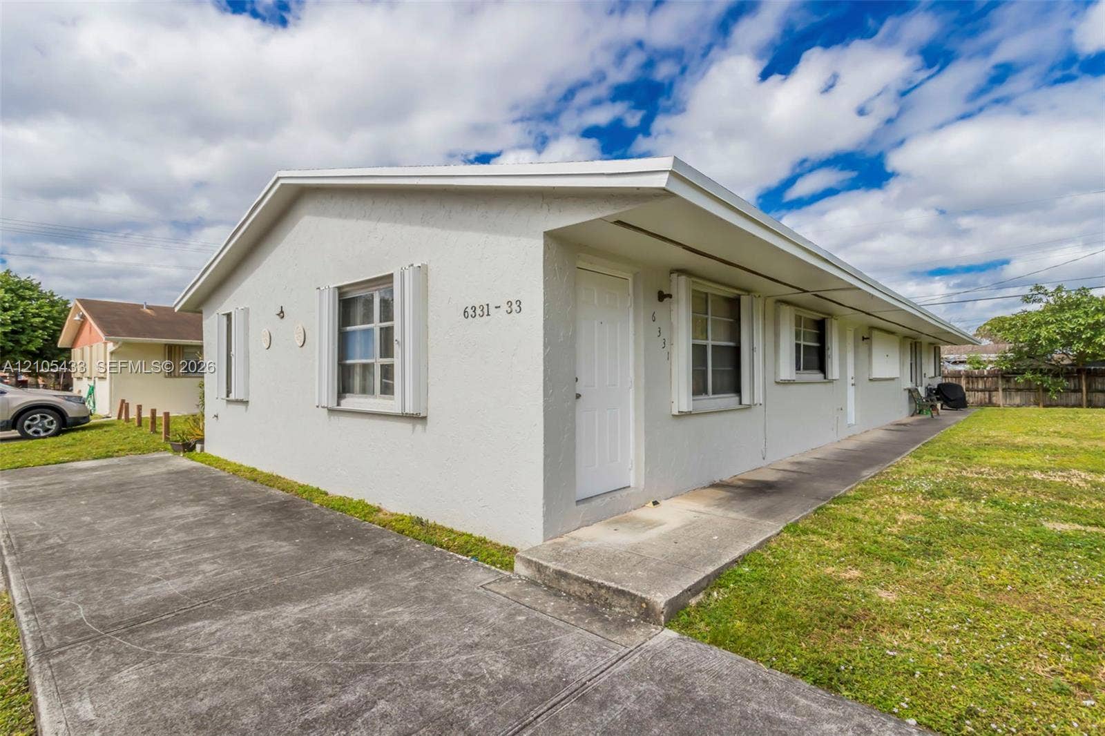 6331 Pierce Street, #1, Hollywood, Hollywood, FL 33024 White stucco exterior with a gabled roofline
