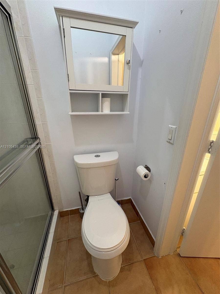 White toilet with a built-in medicine cabinet and an open shelf
