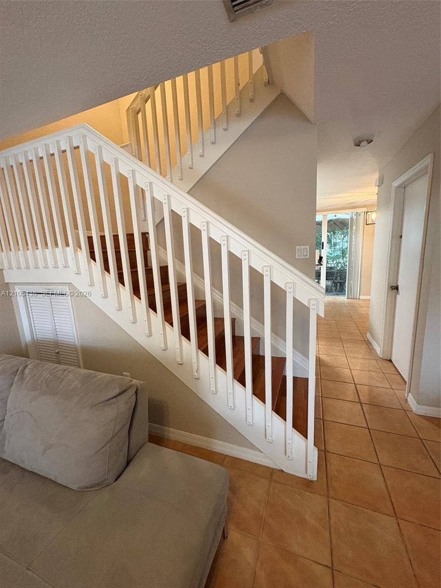 Staircase with wood-finish treads and white balusters