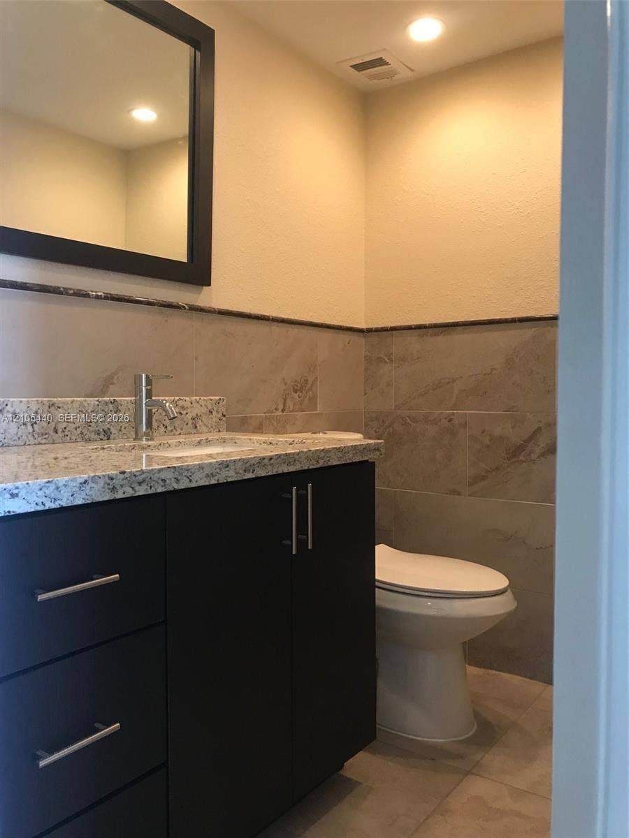 16710 NE 9th Avenue, #707, North Miami Beach, North Miami Beach, FL 33162 Vanity with a granite countertop, undermount sink, and modern faucet