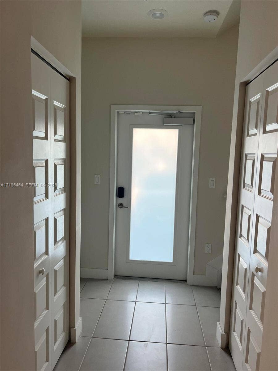 4745 NW 84th Court, #20, Doral, FL 33166 Entryway featuring tile flooring, a frosted glass panel door with a smart lock, and recessed ceiling lighting