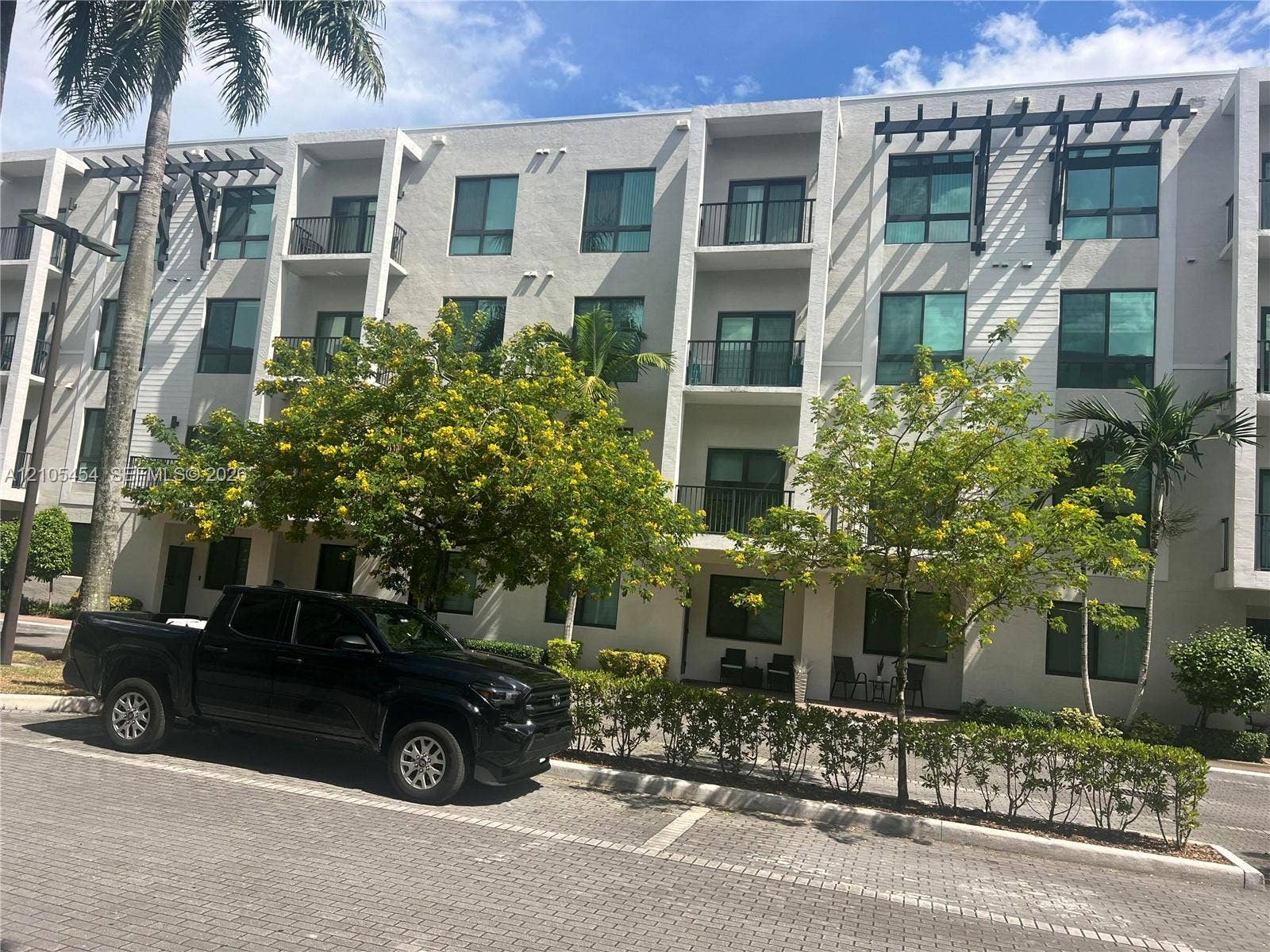 4745 NW 84th Court, #20, Doral, FL 33166 Multi-story structure with private balconies, contemporary windows, and architectural pergolas