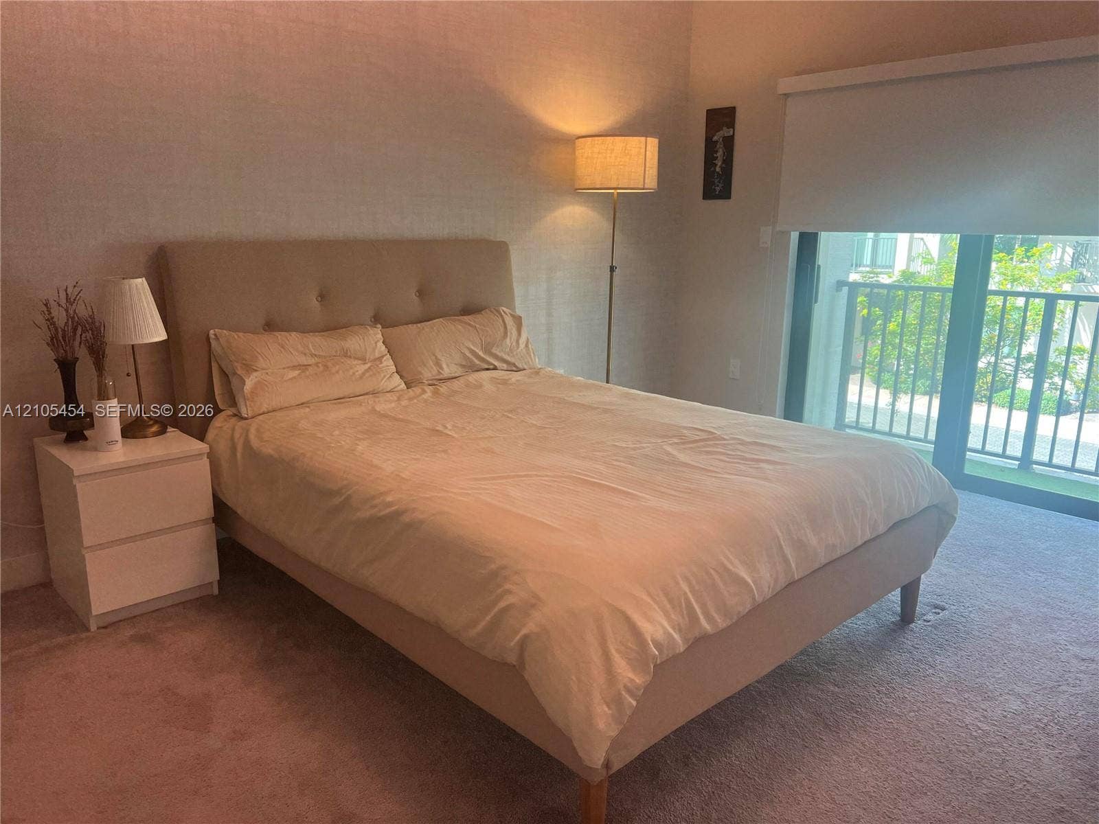 4745 NW 84th Court, #20, Doral, FL 33166 Carpeted flooring, glass sliding door, and a private balcony with railing