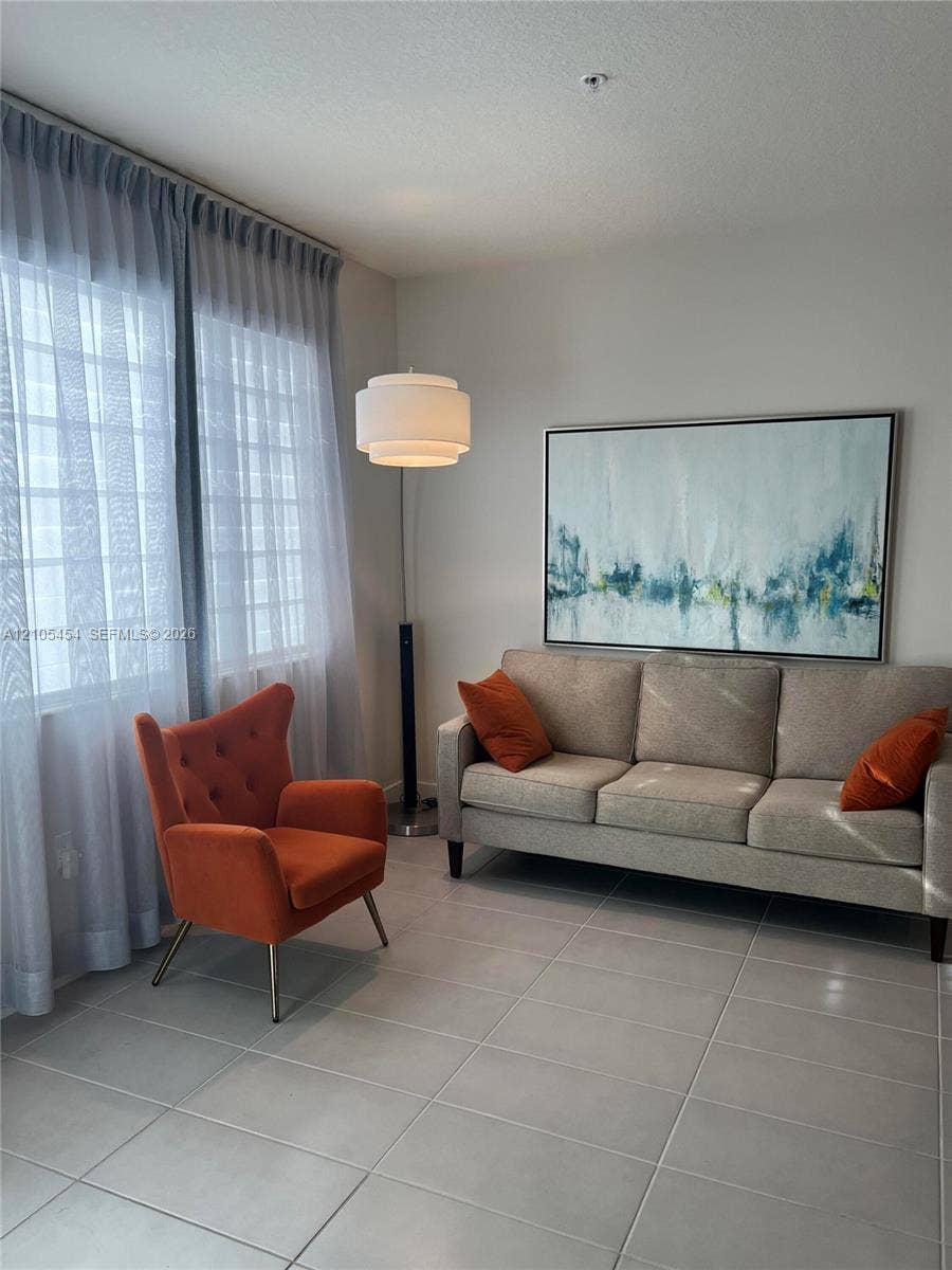 4745 NW 84th Court, #20, Doral, FL 33166 Tile flooring with light grout lines, ceiling-mounted light fixture, and floor-to-ceiling sheer curtains