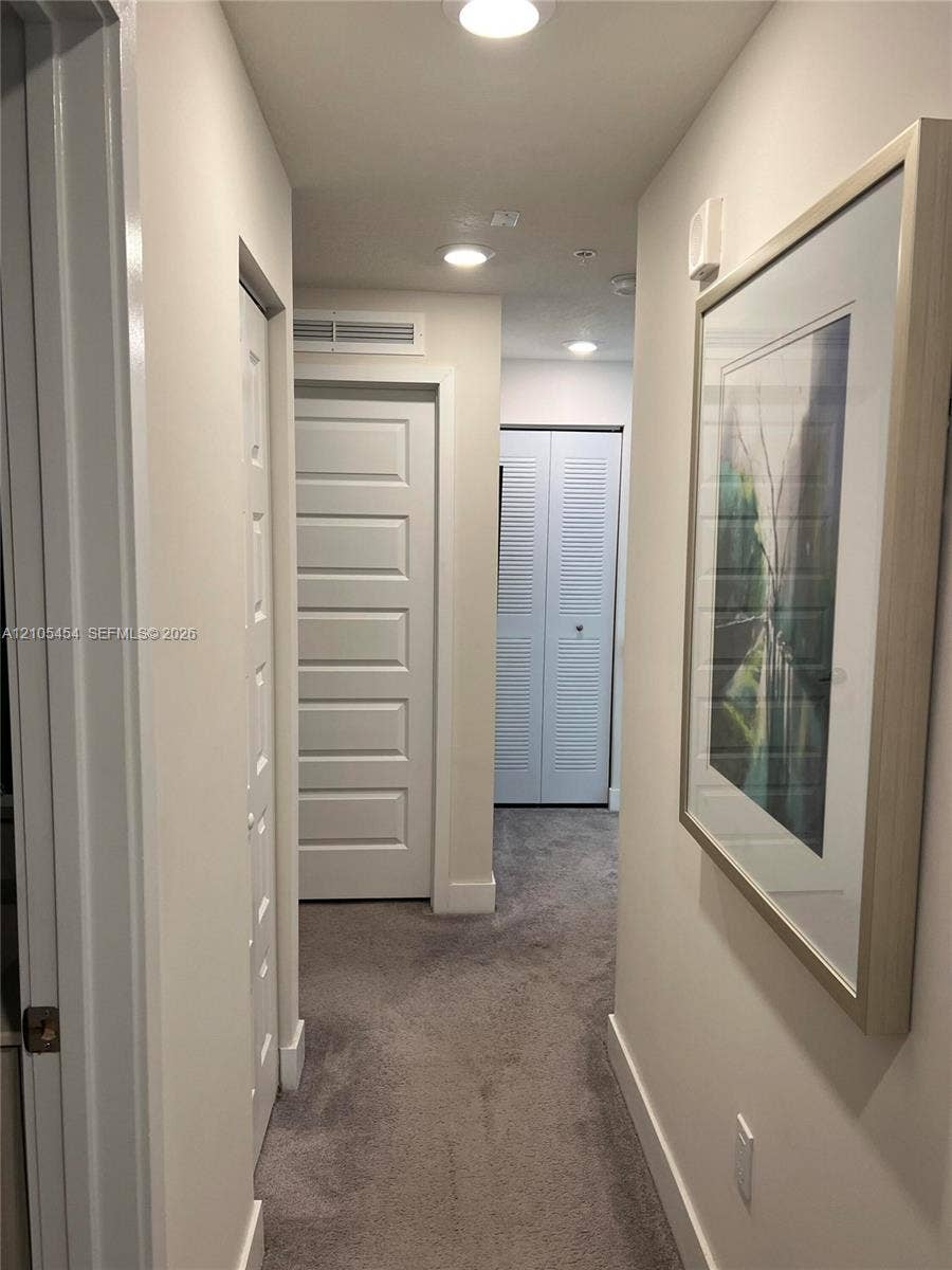 4745 NW 84th Court, #20, Doral, FL 33166 Recessed lighting, plush carpeting, white interior doors, and crisp white trim