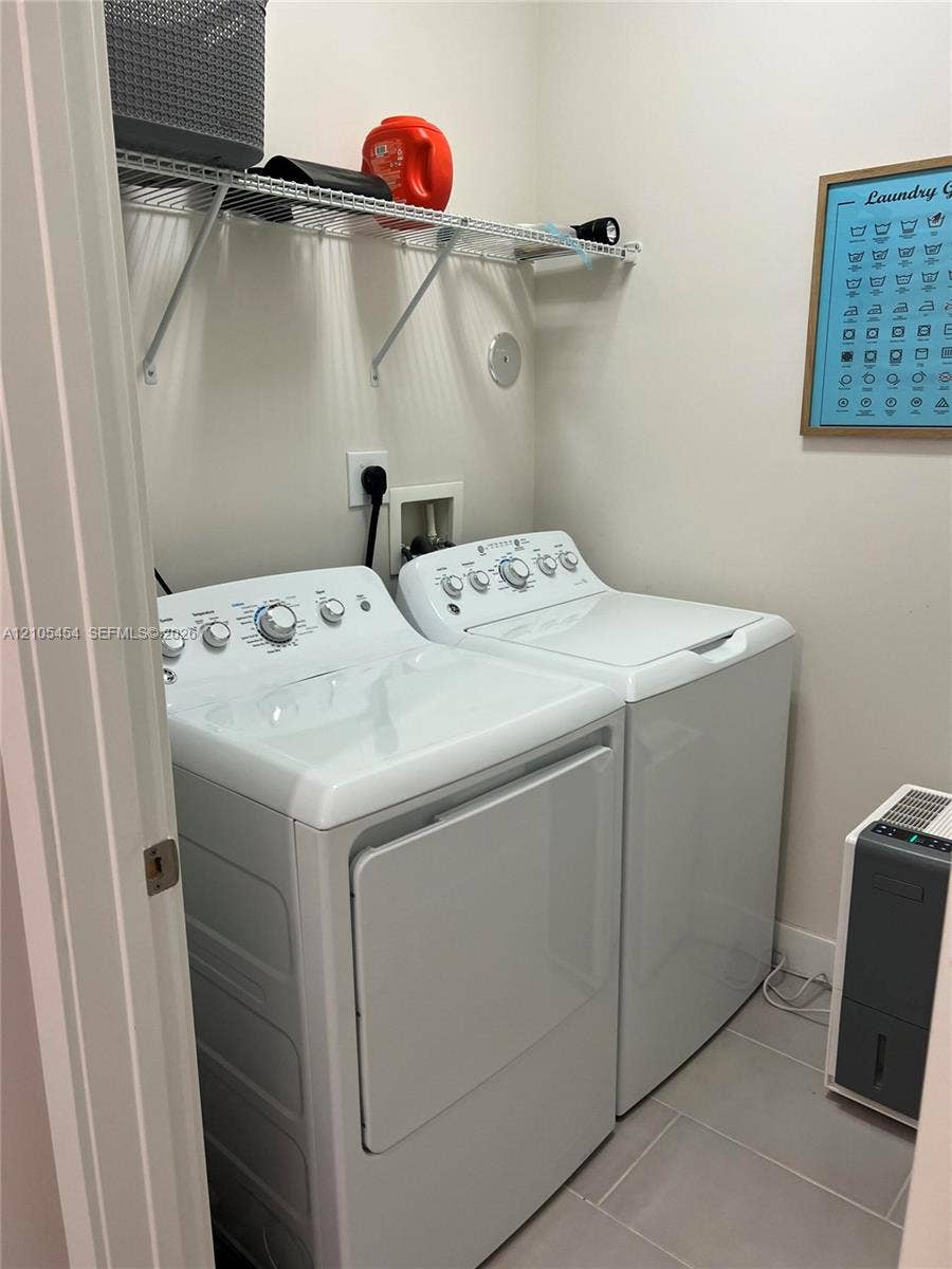 4745 NW 84th Court, #20, Doral, FL 33166 Laundry area featuring a wire storage shelf and light gray floor tiles