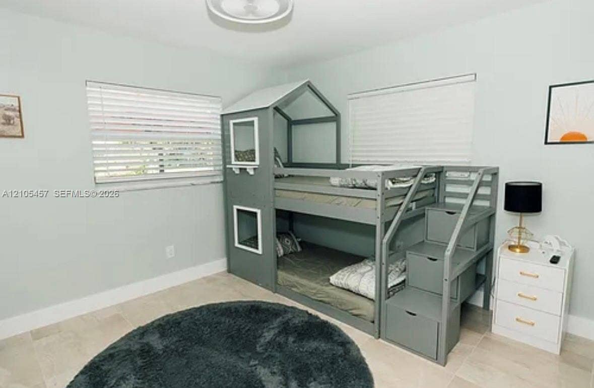 1083 SW 25th Avenue, Boynton Beach, FL 33426 Neutral-toned tile flooring, dual windows with fitted horizontal blinds, and a central flush-mount light fixture
