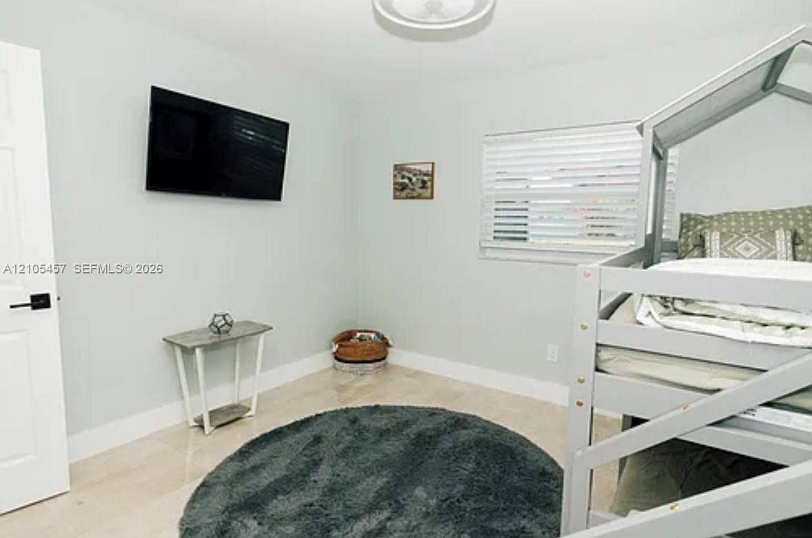 1083 SW 25th Avenue, Boynton Beach, FL 33426 Neutral wall color, light-toned polished tile flooring, horizontal slat blinds, and a semi-flush mount ceiling fixture