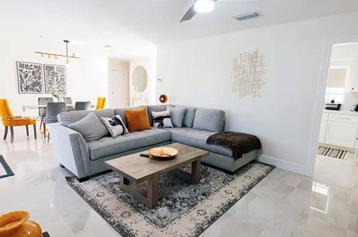 1083 SW 25th Avenue, Boynton Beach, FL 33426 Open-concept living space featuring high-gloss tile flooring, recessed lighting, and a ceiling fan