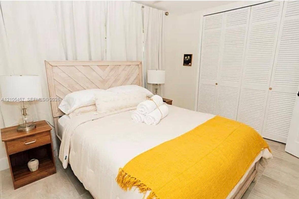 1083 SW 25th Avenue, Boynton Beach, FL 33426 Full-height bi-fold closet doors with louvered panels and tile flooring