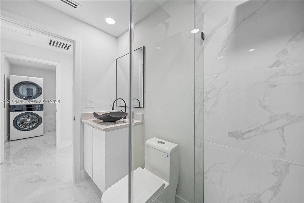 Modern vanity with a vessel sink, single-handle faucet, and built-in cabinetry