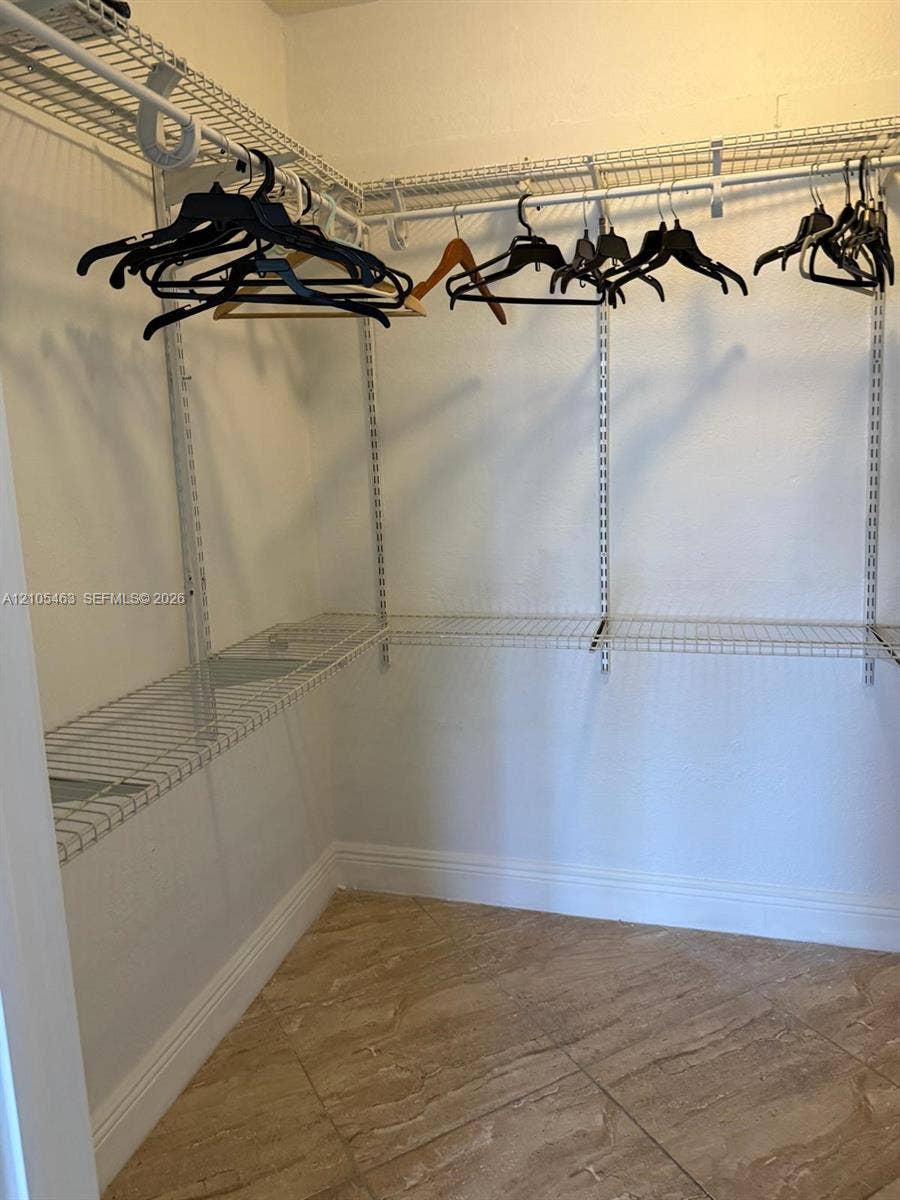 Integrated closet shelving system with hanging rods and tile flooring