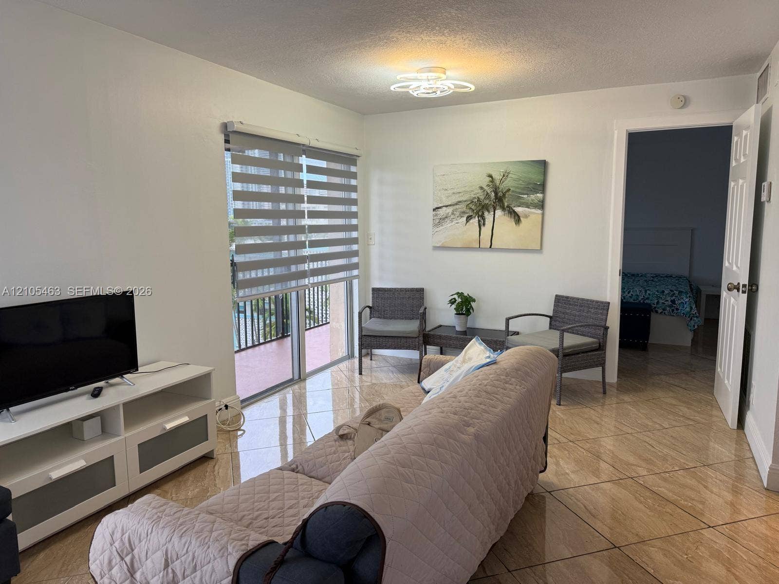 Sliding glass door, tiled flooring, overhead light fixture, and interior doorway