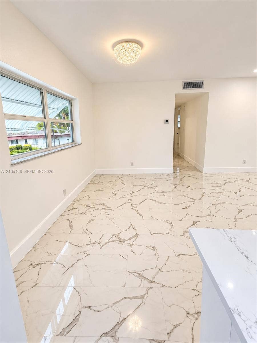 5300 Washington Street, #I201, Hollywood, FL 33021 Recessed lighting, large format tile flooring, crown molding, double-pane window, and a decorative flush mount light fixture