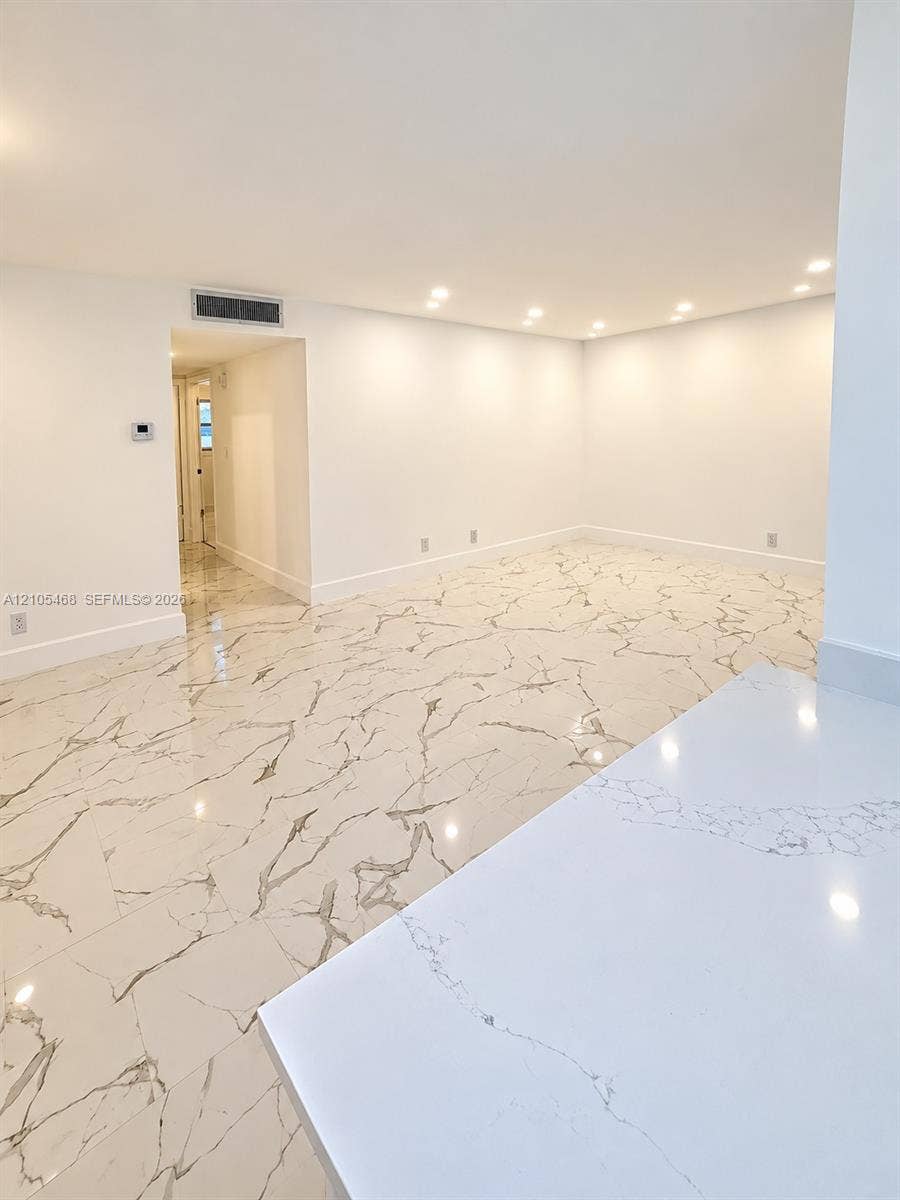 5300 Washington Street, #I201, Hollywood, FL 33021 Spacious room featuring large format tile flooring, recessed ceiling lighting, and crisp white walls