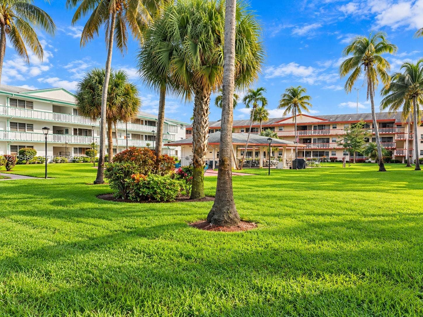 5300 Washington Street, #I201, Hollywood, FL 33021 Expansive green lawn with mature palm trees and tropical landscaping