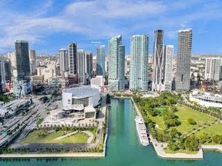 888 Biscayne Boulevard, #811, Miami, FL 33132 Urban skyline featuring multiple high-rise buildings, a prominent waterfront, a large arena structure, and landscaped green spaces