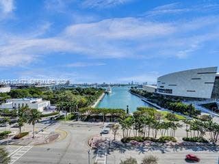888 Biscayne Boulevard, #811, Miami, FL 33132 Cityscape with prominent waterfront, lush landscaping, modern architectural structures, and urban infrastructure